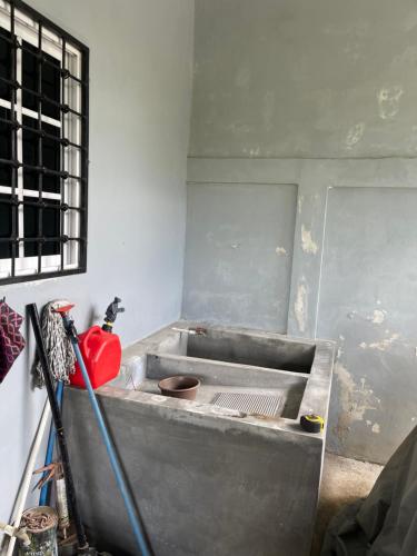 a metal sink in a room with a window at Casa en Puero Cortes in Puerto Cortes