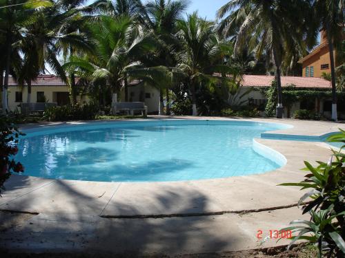 a large swimming pool with palm trees around it at BONITO APARTAMENTO RODEADO DE PALMERAS primer nivel in Barra de Navidad