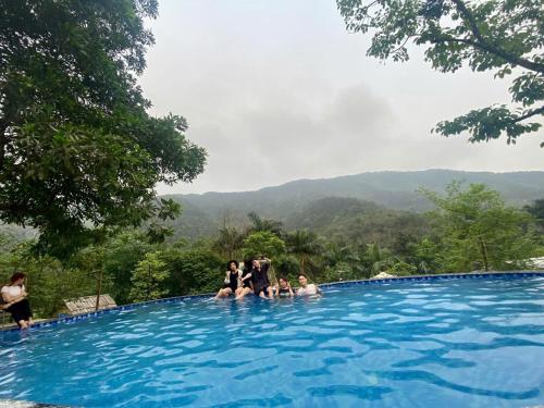 a group of people sitting in a swimming pool at May Homestay Soc Son - Venuestay in Hanoi