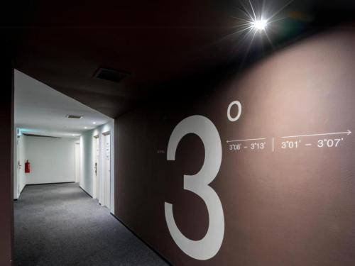 a dark hallway with a sign on the wall at Sky Hotel Cheras Maluri in Kuala Lumpur