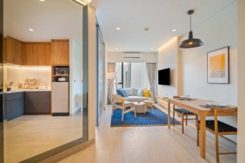 a kitchen and living room with a table and a dining room at Laguna Lakeside Residences by Banyan Living in Bang Tao Beach