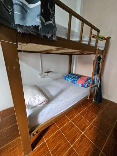 a bunk bed in a room with a bunk bedscribed at Bami hostel in Thakhek