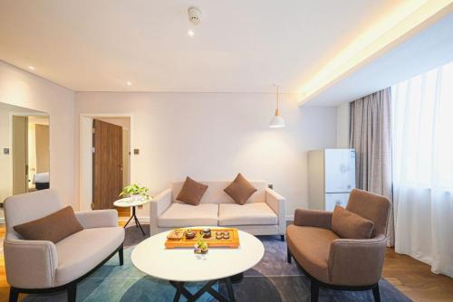 a living room with a couch and chairs and a table at Holiday Inn Express Quanzhou City Center by IHG in Quanzhou