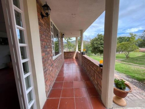 a porch of a house with a brick wall at Finca La Esperanza in Nobsa