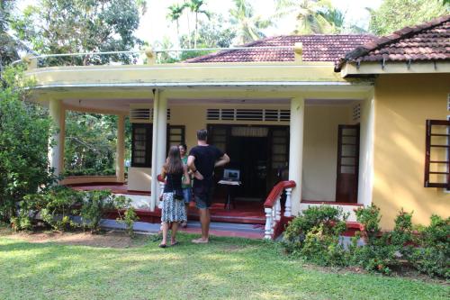 two people standing on the porch of a house at Abberny villa in Midigama