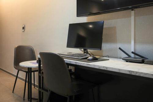 a desk with a computer on top of it at Hwaseong Stay13 Hotel in Hwaseong