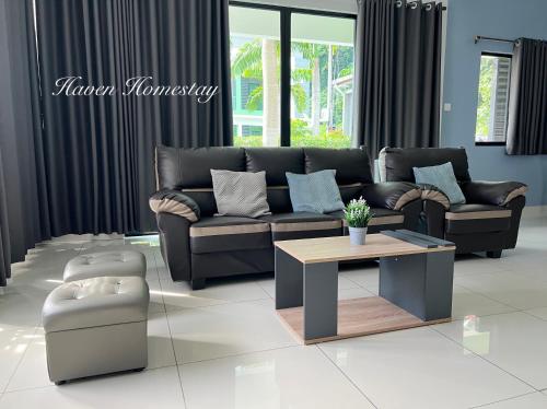 a living room with a couch and a coffee table at Haven Homestay晶晶屋 (Brand New Homestay!) in Kampong Sungai Udang