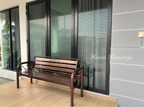a wooden bench sitting in front of a window at Haven Homestay晶晶屋 (Brand New Homestay!) in Kampong Sungai Udang
