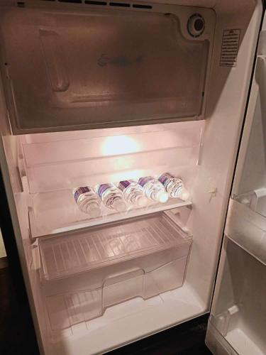 an open refrigerator with food inside of it at Be Local BNB in Bangkok