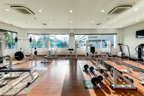 a gym with a lot of treadmills and machines at Sunflower International Village in Hai Phong