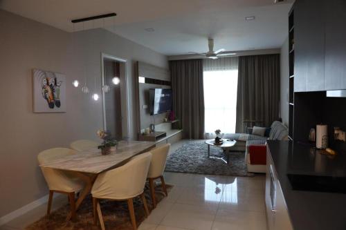 a kitchen and living room with a table and chairs at Luxury Apt close to KLCC Aria in Kuala Lumpur