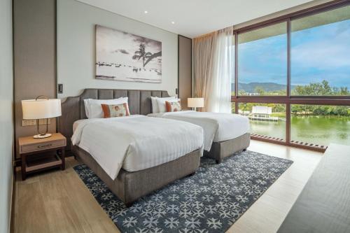 Postel nebo postele na pokoji v ubytování Angsana Oceanview Residences by Banyan Living