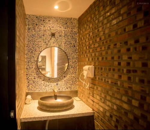 a bathroom with a sink and a mirror at 北京怀柔方糖民宿 in Sanduhe