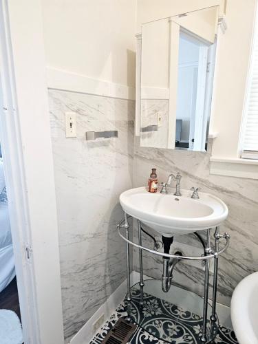 a bathroom with a sink and a mirror at Cozy Craftman Cottage in Quiet Historic Vallejo Neighborhood in Vallejo