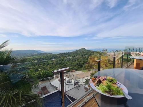 a plate of food on a table on a balcony at The Resort Phu Fah Chai Nam in Ban Khanan Chit