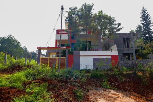 a house sitting on the side of a hill at Lakeside Home Stay Villa in Yelagiri