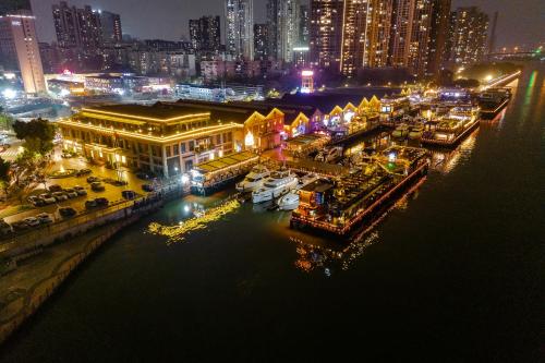 a marina at night with boats in the water at Yushe High-altitude Night View Hotel-Guangzhou Tower Zhujiang New Town Branch Exclusive for the Canton Fair in Guangzhou