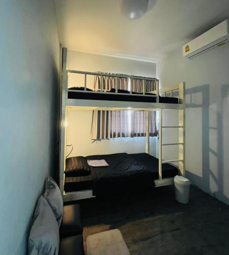 a bedroom with two bunk beds in a room at Patone Hostel in Phra Nakhon Si Ayutthaya