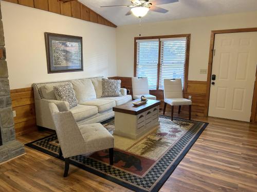 a living room with a couch and a table at Tucked Away Cabin in Pigeon Forge