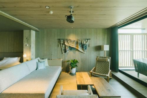 a living room with a large couch and a table at HOTEL & KOTEI SOKA in Kyotango
