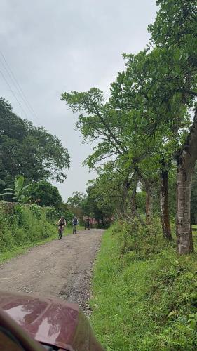a group of people riding bikes on a dirt road at Glamping la cabaña in La Ermita