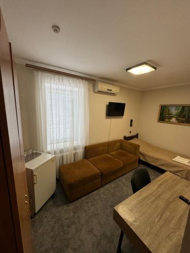 a living room with a couch and a bed at Садиба in Kamianets-Podilskyi