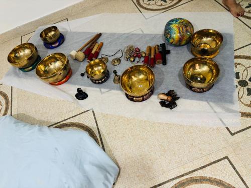 a group of bells and other items on a table at Krishnabalram wellness & Ayurveda centre in Rishīkesh