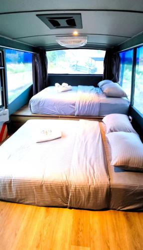 a bedroom with two beds in the back of a bus at Campod Resort @ Cameron Highlands in Cameron Highlands