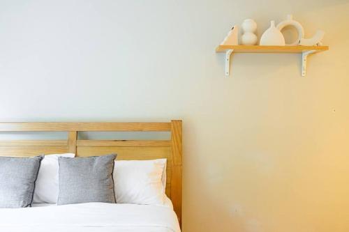 a bed with white pillows and a wooden head board at 3B3B w Farm View w Outdoor Dining,Shared Game Room in Bilpin