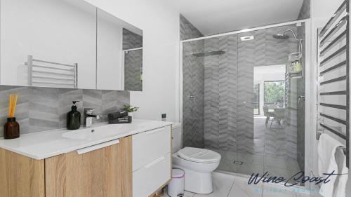 a bathroom with a toilet and a sink and a shower at HaltandHide by Wine Coast Holiday Rentals in Seaford
