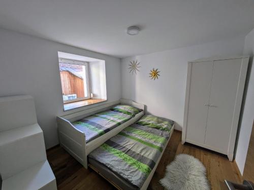 a small room with a bed and a window at Ferienwohnung Gurgltal in Nassereith