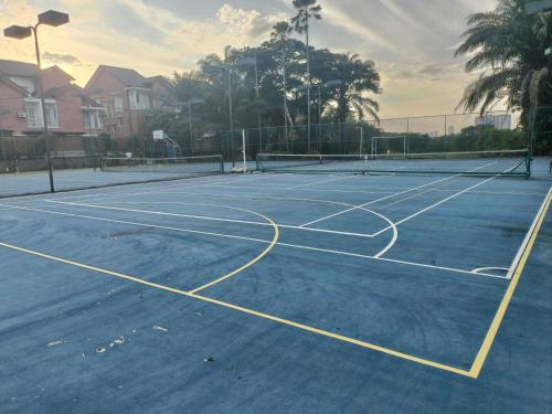 a tennis court with a net on it at Sungai Long Homestay in Kajang