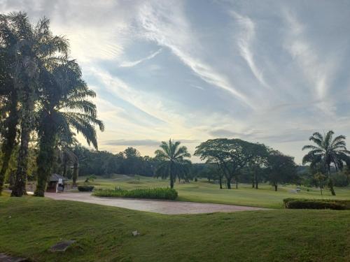 a park with palm trees and a golf course at Sungai Long Homestay in Kajang