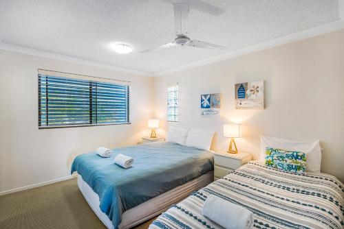 a bedroom with two beds and a window at Salty Kisses @ Riverdance - 3 bedroom apartment in Mooloolaba