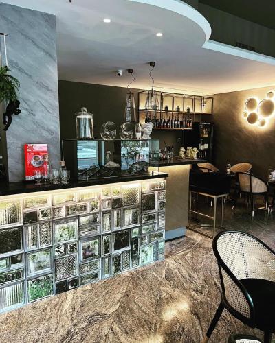 a restaurant with a counter with dishes on it at Salotto "900Strati" in Bergamo