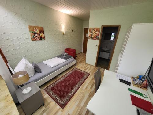 a small room with a bed and a wall at Hotel Schönblick in Bad Herrenalb