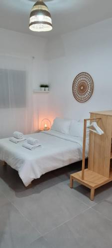 a bedroom with a bed and a lamp and a chair at Desert Shine in Qiryat Gat
