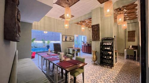 a dining room with a table and a room with chairs at The Center Point in Siem Reap