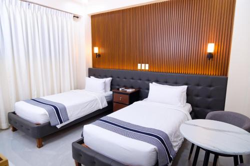 a hotel room with two beds and a table at Le Dream Hotel near Vigan in Anomang Mayor