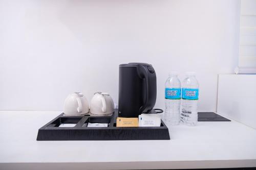 a coffee maker and two bottles of water on a counter at Le Dream Hotel near Vigan in Anomang Mayor