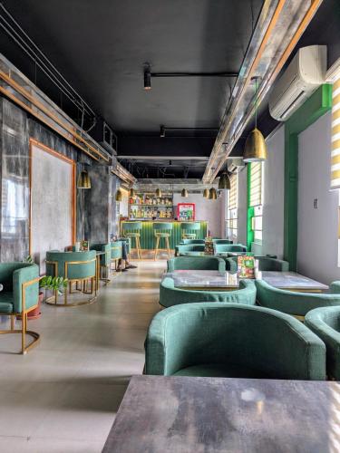 a dining room with green chairs and tables at Niko Hotels in Cochin