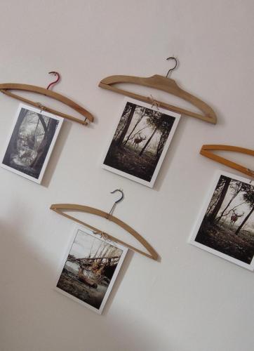 a wall with photos hanging on a wall at A casa di zia Maly in Palena