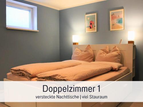 a bedroom with a bed with pillows and a window at Möbliert Wohnen Munich Airport Business Park in Hallbergmoos