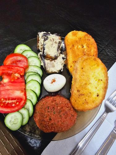 a plate of food with vegetables and chicken tenders at Guesthouse different in Tbilisi City