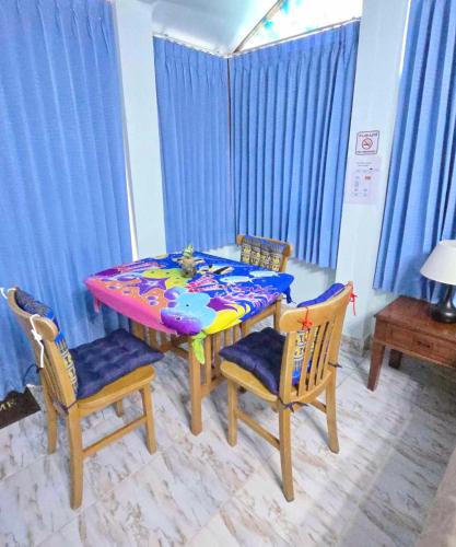 a dining room table with chairs and a colorful table at Lanta MP Place in Ko Lanta
