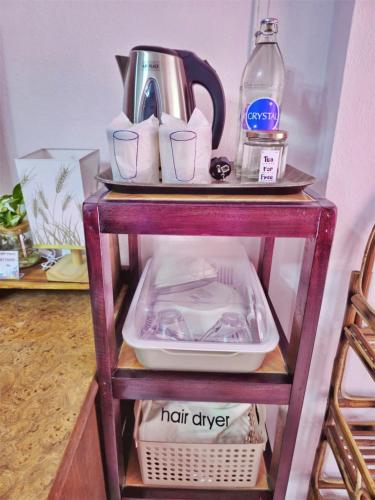 a shelf with a tea kettle and cups on it at Lanta MP Place in Ko Lanta