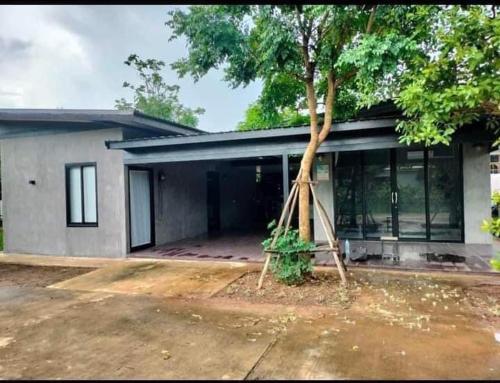 a house with a tree in front of it at Coco Residence, Si Saket in Khun Han