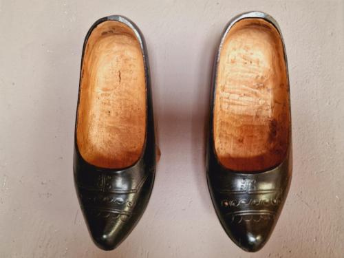a pair of black shoes sitting on a table at MIRADORES de Apartamentos Rufaste in Salardú