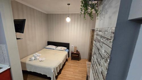 a small bedroom with a bed and a tv at Guesthouse Family in Tbilisi City