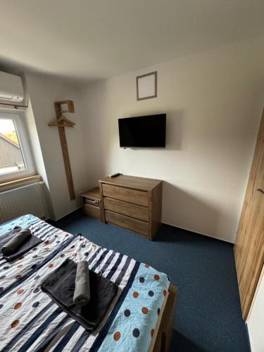 a bedroom with a bed and a tv on the wall at Čistá v Krkonoších - Chata Belmonda in Cerny Dul